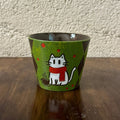 Handmade ceramic mug with cute white cat in red scarf, green speckled glaze, and coffee cup design