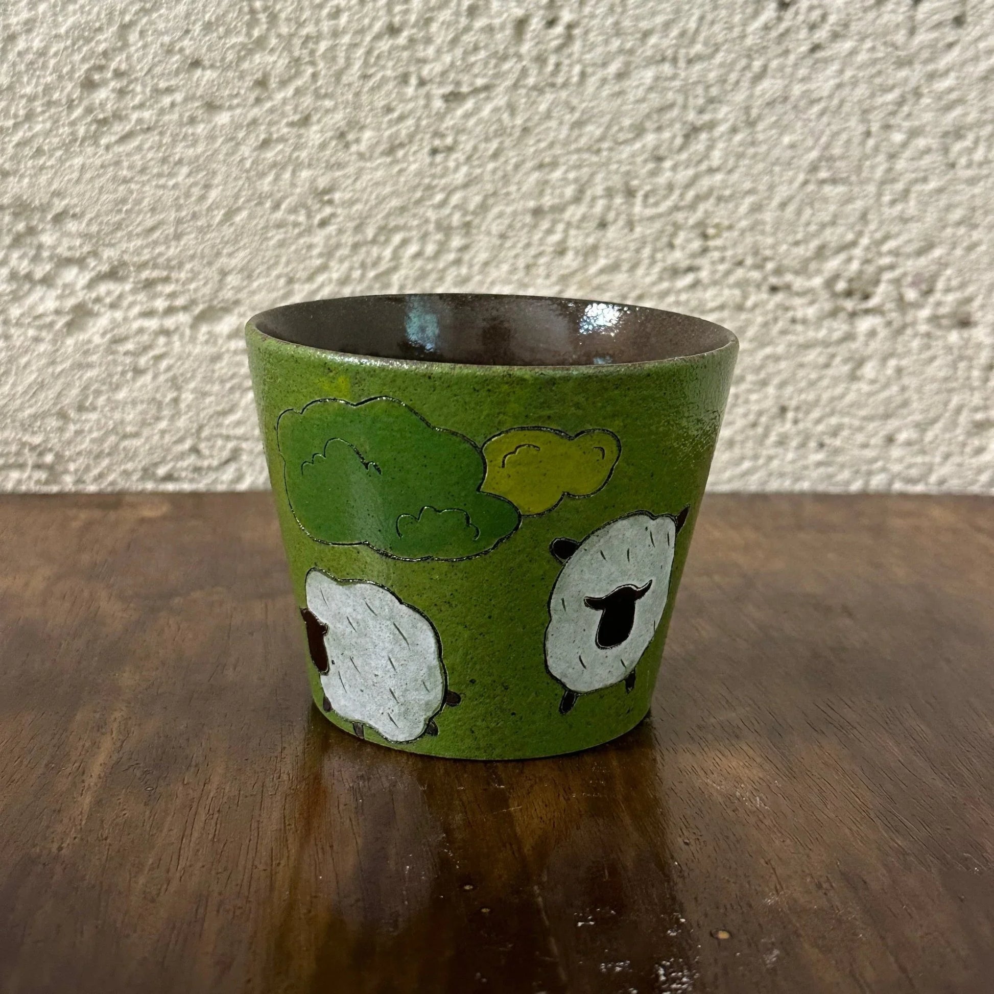 Handmade ceramic mug with sheep and clouds design, green glaze, food-safe tableware