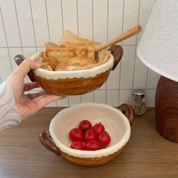 Handmade ceramic bowls with scalloped edges holding bread and cherry tomatoes, perfect for serving snacks or breakfast.